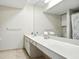 Bright bathroom featuring dual sinks, a long vanity, and shower with a glass door at 6851 Roswell Rd # F5, Sandy Springs, GA 30328