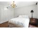 Charming bedroom with neutral color palette and decorative chandelier at 6851 Roswell Rd # F5, Sandy Springs, GA 30328