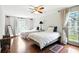 Bright bedroom with hardwood floors, ceiling fan, and plenty of natural light at 6851 Roswell Rd # F5, Sandy Springs, GA 30328