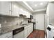 Well-lit kitchen with stainless steel appliances, tile backsplash, and modern countertops at 6851 Roswell Rd # F5, Sandy Springs, GA 30328