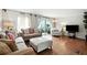 Cozy living room featuring hardwood floors and access to an outdoor balcony at 6851 Roswell Rd # F5, Sandy Springs, GA 30328