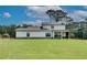 Expansive backyard with a well-maintained lawn and charming covered patio at 1611 Alcovy Station Rd, Covington, GA 30014