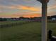 Scenic backyard view at sunset, showcasing the expansive lawn and serene surroundings at 1611 Alcovy Station Rd, Covington, GA 30014