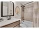 Bathroom with a modern vanity, framed mirror, and shower-tub combo at 1611 Alcovy Station Rd, Covington, GA 30014