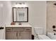 Well-lit bathroom featuring a vanity with framed mirror and modern fixtures at 1611 Alcovy Station Rd, Covington, GA 30014