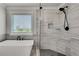 This bathroom features a modern tub, glass shower with upgraded shower head and tasteful tiling at 1611 Alcovy Station Rd, Covington, GA 30014