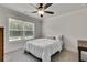Cozy bedroom with window and ceiling fan at 1611 Alcovy Station Rd, Covington, GA 30014