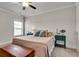 Comfortable bedroom with soft carpet, ceiling fan, and a well-lit window at 1611 Alcovy Station Rd, Covington, GA 30014