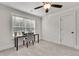 Bright bedroom features a ceiling fan, large window with blinds and a modern desk at 1611 Alcovy Station Rd, Covington, GA 30014