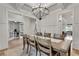 Stunning dining area with a modern chandelier, wood table, and views into the office and kitchen at 1611 Alcovy Station Rd, Covington, GA 30014