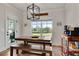 Dining room featuring a rustic table, bench seating, and natural light from the large window overlooking the backyard at 1611 Alcovy Station Rd, Covington, GA 30014
