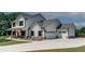 Stylish two-story home featuring a spacious three-car garage, inviting front porch, and manicured lawn at 1611 Alcovy Station Rd, Covington, GA 30014