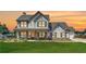 Charming two-story home with inviting front porch, shutters, green lawn, and an American flag at 1611 Alcovy Station Rd, Covington, GA 30014