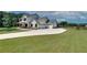 Stunning white farmhouse with a spacious driveway leading to a three-car garage at 1611 Alcovy Station Rd, Covington, GA 30014
