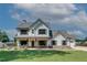 Charming two-story home with inviting front porch, shutters, green lawn, and an American flag at 1611 Alcovy Station Rd, Covington, GA 30014