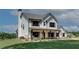 Charming two-story home with inviting front porch, shutters, a green lawn, and wooden fence at 1611 Alcovy Station Rd, Covington, GA 30014