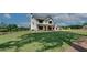 Inviting two-story white farmhouse with a covered porch and lush green lawn at 1611 Alcovy Station Rd, Covington, GA 30014
