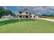 Charming two-story white farmhouse featuring a covered porch and well-manicured lawn at 1611 Alcovy Station Rd, Covington, GA 30014
