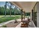 Inviting outdoor porch with wooden pillars and a peaceful place for outdoor seating with view of green lawn at 1611 Alcovy Station Rd, Covington, GA 30014
