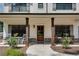 Inviting front porch with dark wooden pillars and neutral colored walls with two sets of rocking chairs at 1611 Alcovy Station Rd, Covington, GA 30014