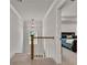 Hallway with neutral carpet and railing with view into the bedroom at 1611 Alcovy Station Rd, Covington, GA 30014