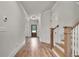 Bright hallway with hardwood floors, white trim, and a wooden front door at 1611 Alcovy Station Rd, Covington, GA 30014
