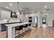 Well-lit kitchen features a large island with seating, stainless steel appliances, and hardwood flooring at 1611 Alcovy Station Rd, Covington, GA 30014