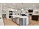 Open concept kitchen featuring a large island, stainless steel appliances, and hardwood floors at 1611 Alcovy Station Rd, Covington, GA 30014