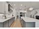 Modern kitchen with white cabinets, stainless steel appliances, a large island, and hardwood floors at 1611 Alcovy Station Rd, Covington, GA 30014