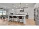 Bright kitchen featuring an island, stylish pendant lighting, stainless appliances, and hardwood floors at 1611 Alcovy Station Rd, Covington, GA 30014