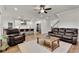 Open concept kitchen and living room with leather furniture and hardwood floors at 1611 Alcovy Station Rd, Covington, GA 30014