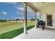 Covered patio with picturesque views and outdoor cooking setup at 1611 Alcovy Station Rd, Covington, GA 30014