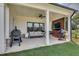 Covered outdoor patio features a grill, comfortable seating, and a tv at 1611 Alcovy Station Rd, Covington, GA 30014