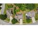 Aerial view of a home showcasing its lush green landscaping, driveway, and surrounding neighborhood at 454 Pine Bluff Dr, Dallas, GA 30157