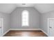 Finished attic offers an arched window and wood-look floors, adding charm and character at 454 Pine Bluff Dr, Dallas, GA 30157