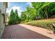 A spacious brown deck with railings overlooks a lush, green yard with mature trees and landscape at 454 Pine Bluff Dr, Dallas, GA 30157