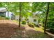 The home's backyard features lush landscaping, mature trees, and a well-maintained lawn at 454 Pine Bluff Dr, Dallas, GA 30157