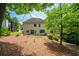 The home's backyard features lush landscaping, mature trees, and a well-maintained lawn at 454 Pine Bluff Dr, Dallas, GA 30157