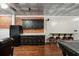 Basement kitchenette features black cabinetry, granite counters, and barstool seating at 454 Pine Bluff Dr, Dallas, GA 30157