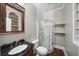 Bathroom with tiled shower, elegant vanity, and convenient built-in shelving at 454 Pine Bluff Dr, Dallas, GA 30157