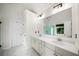 Bright bathroom featuring a double vanity with marble countertop, tile floors, and a large mirror at 454 Pine Bluff Dr, Dallas, GA 30157
