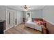 Cozy bedroom with natural light, wood-paneled walls, and decorative pillows at 454 Pine Bluff Dr, Dallas, GA 30157