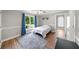Bedroom with wood floors, large window with blue curtains, and connected bathroom at 454 Pine Bluff Dr, Dallas, GA 30157