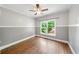 Bedroom with wood-paneled walls, wood floors, and bright backyard views at 454 Pine Bluff Dr, Dallas, GA 30157
