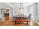 Elegant dining room with modern lighting, hardwood floors, and ample seating for Gathering and guests at 454 Pine Bluff Dr, Dallas, GA 30157
