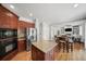 Open kitchen area with island, stainless appliances, and seamless flow into the living and dining spaces at 454 Pine Bluff Dr, Dallas, GA 30157