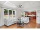 Bright living room with hardwood floors, views into the kitchen, and natural light from large windows at 454 Pine Bluff Dr, Dallas, GA 30157