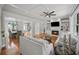 Open-concept living area with fireplace, built-in shelves, hardwood floors, and view into the dining room at 454 Pine Bluff Dr, Dallas, GA 30157