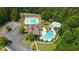 Overhead view showcasing community pool with clubhouse, spa, and sunbathing area surrounded by mature trees at 454 Pine Bluff Dr, Dallas, GA 30157