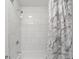 Bright shower features marble tile and a shower curtain at 454 Pine Bluff Dr, Dallas, GA 30157
